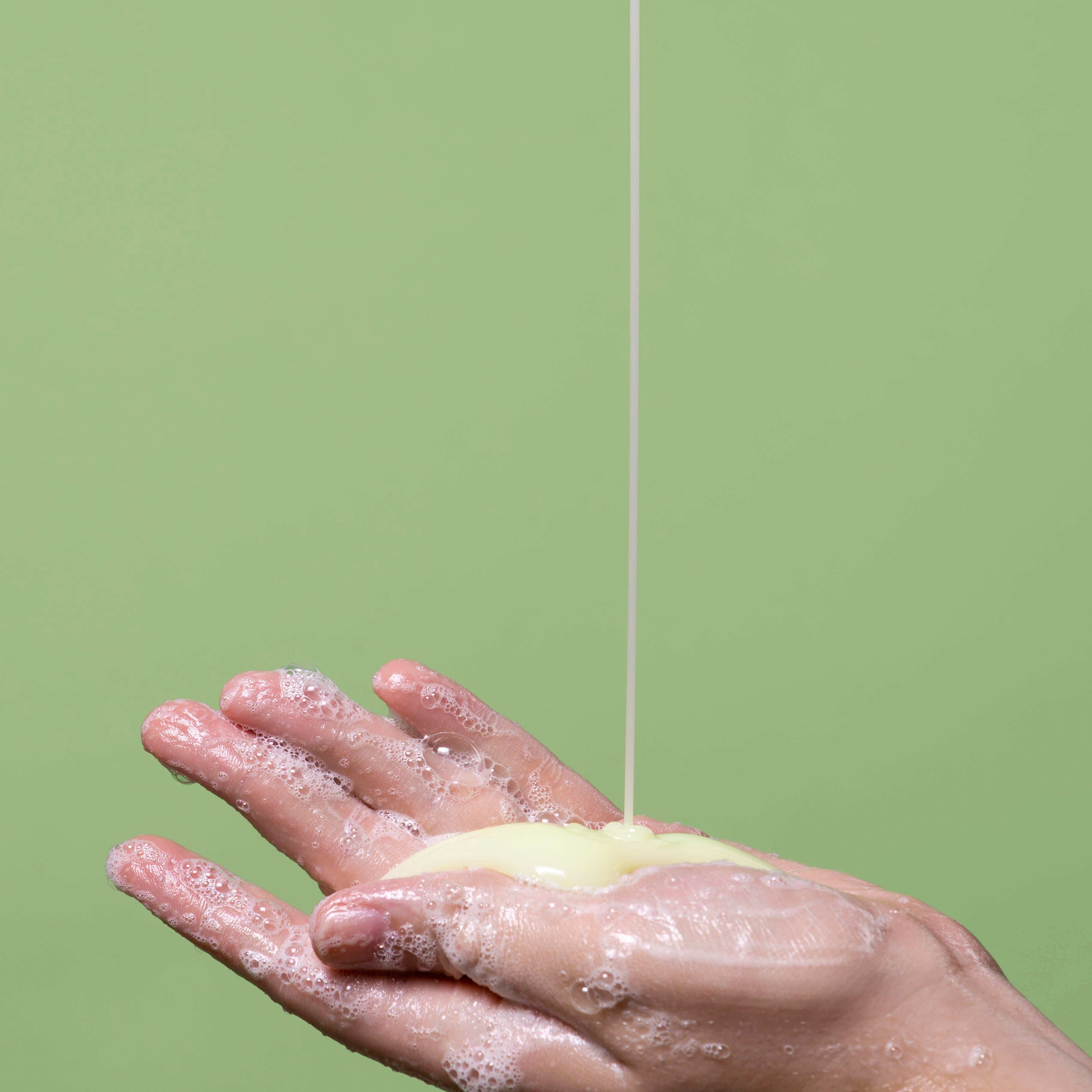 lathering up face wash in hand with sulfur wash for acne