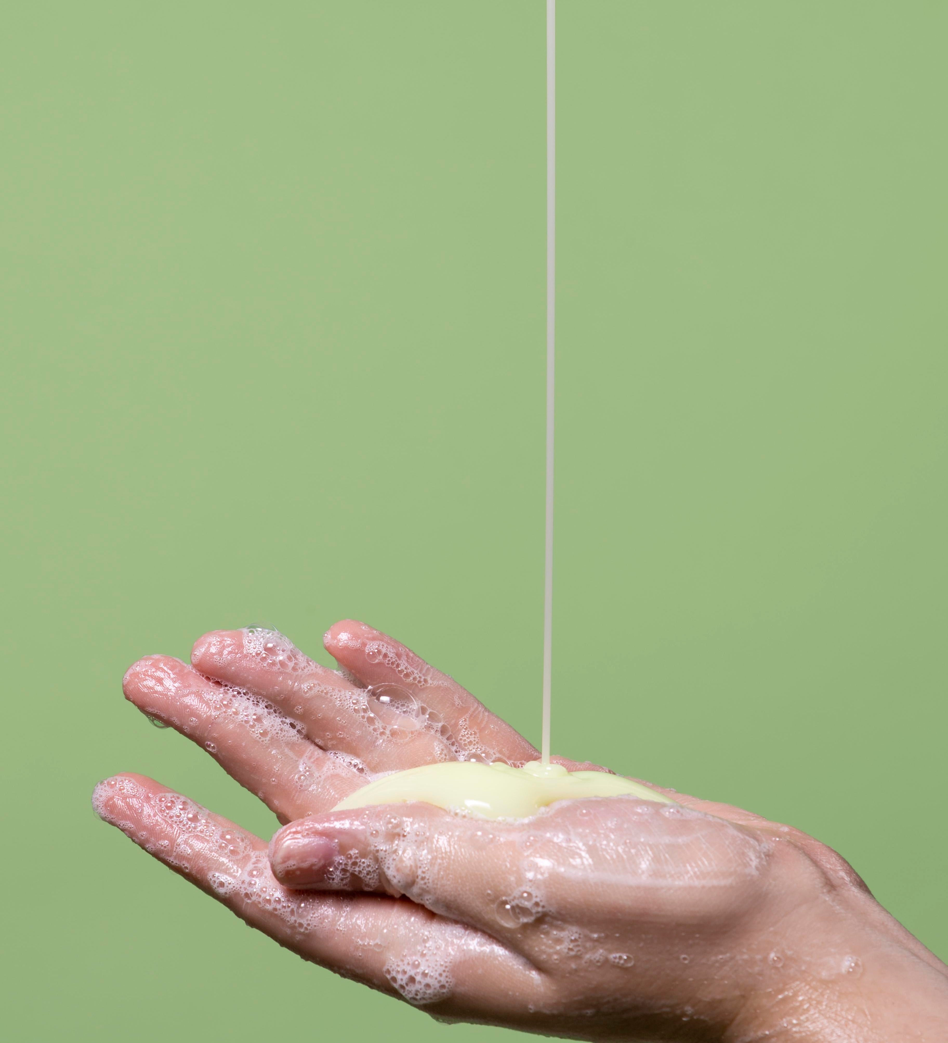 lathering up face wash in hand with sulfur wash for acne