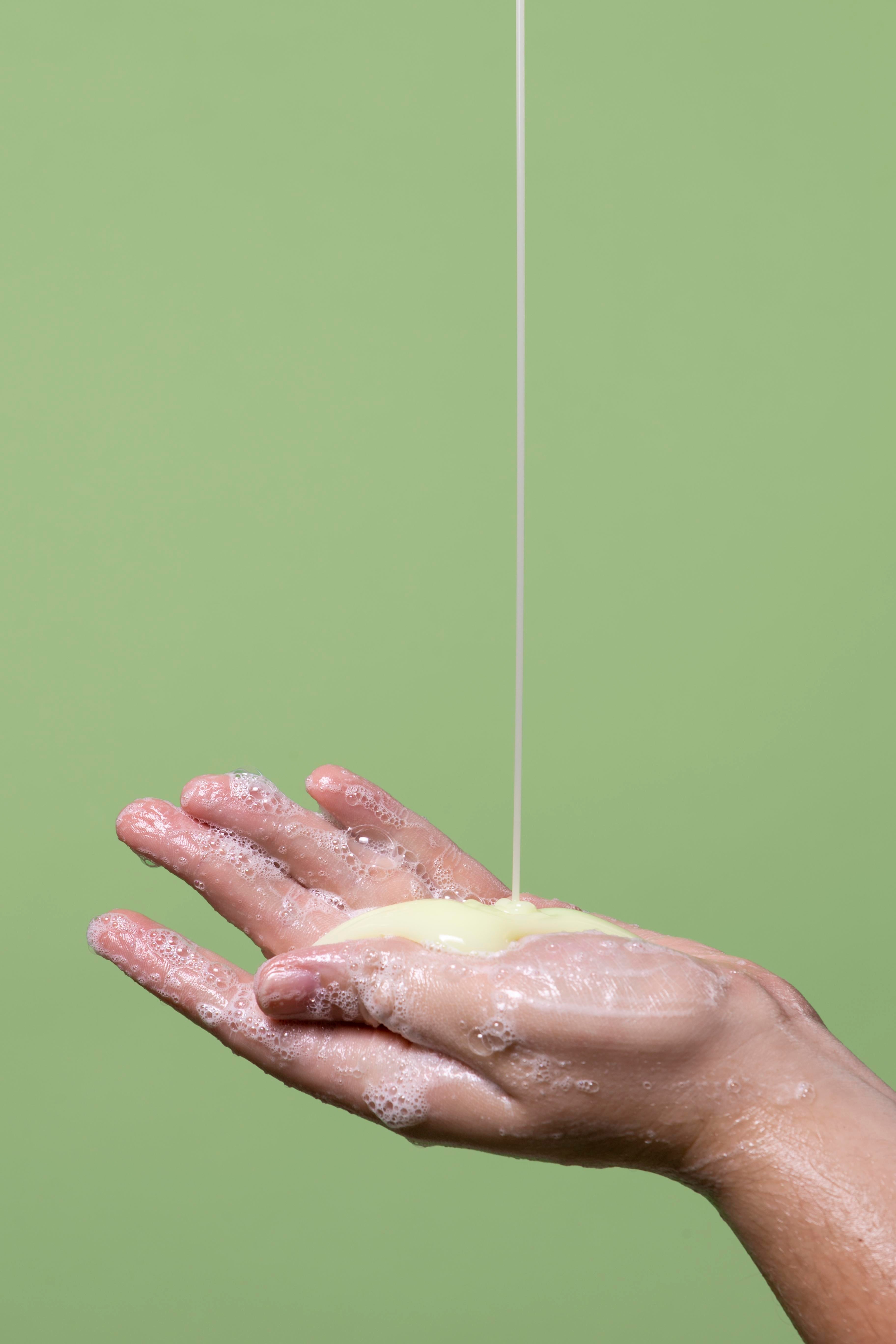lathering up face wash in hand with sulfur wash for acne