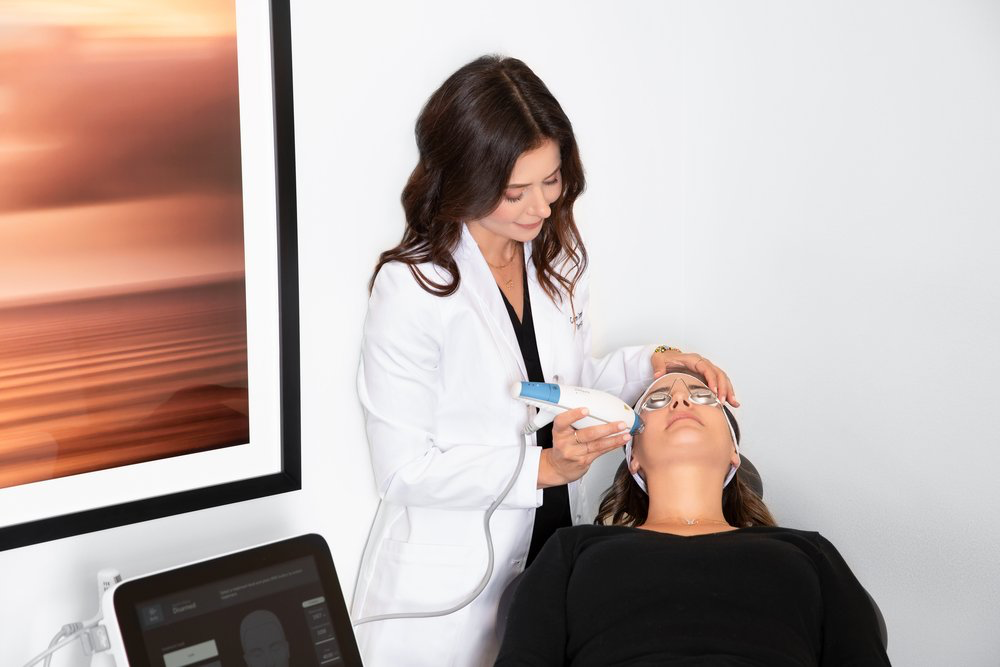 Dr. Caren Campbell performing Clear + Brilliant laser or the 'mini Fraxel' treatment to a patient at her dermatology clinic in San Francisco. Clear and Brilliant improves skin texture and tone.